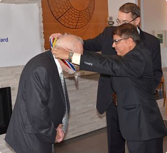 H.E. Kali Pokhrel places Hillary Medal on Dr. Jack Ives